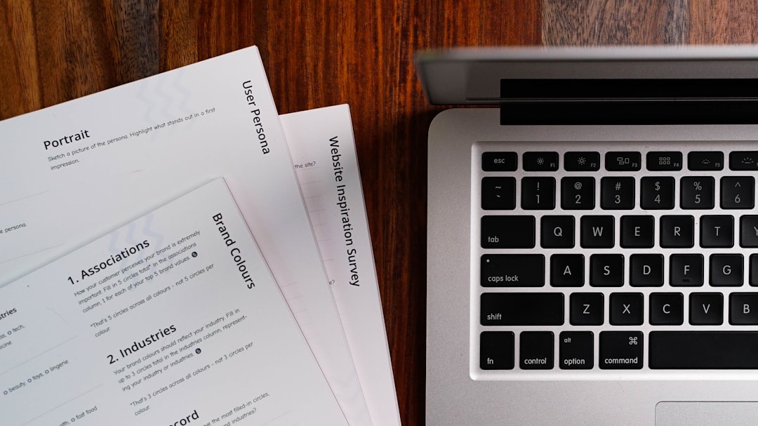 scanned document and laptop workspace — Photo by 2H Media on Unsplash. Source: https://unsplash.com/photos/a-laptop-computer-sitting-on-top-of-a-wooden-table-HNP2rhaOs0U