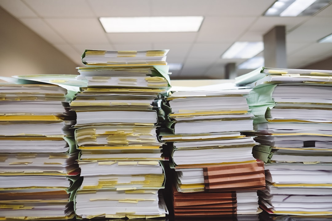 large stack of documents on desk — Photo by Wesley Tingey on Unsplash. Source: https://unsplash.com/photos/stacks-of-paper-documents-and-file-folders-snNHKZ-mGfE